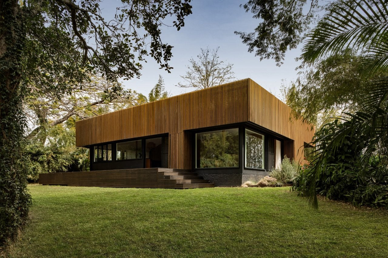 SOMA Home, a modern house framed by forest 